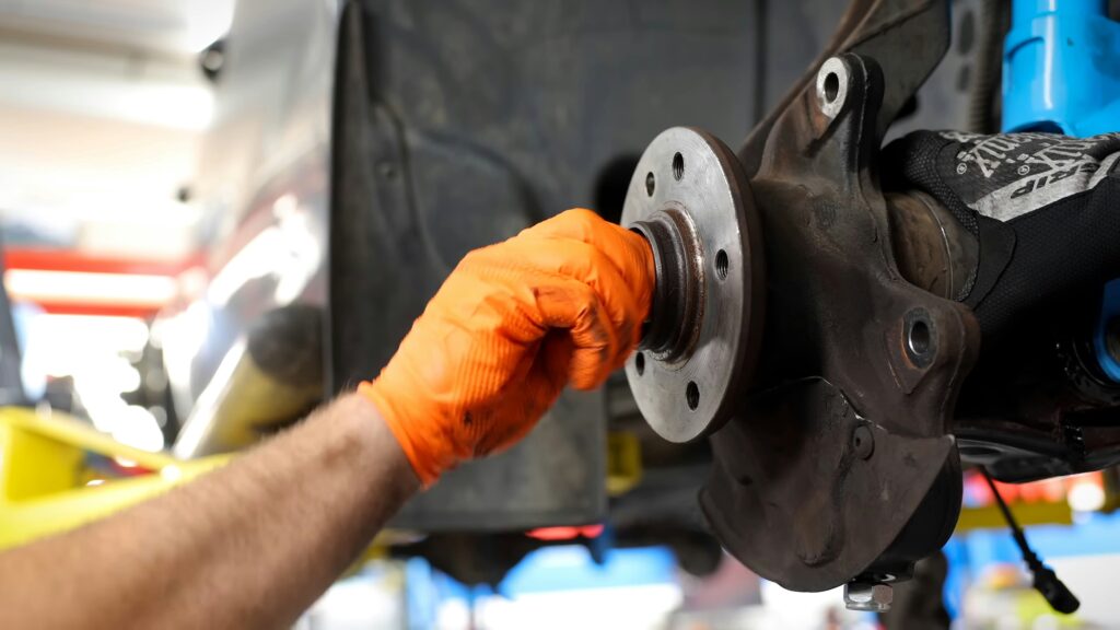 mechanic installing brake pads in Westland repair shop